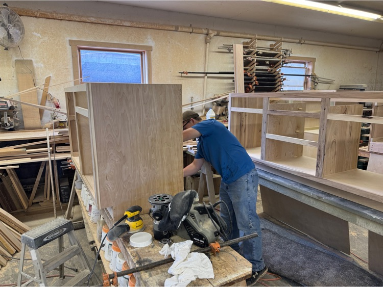 Nick putting back on cabinets
